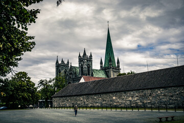 Nidaros Cathedral in Trondheim. Dark clouds over the city.