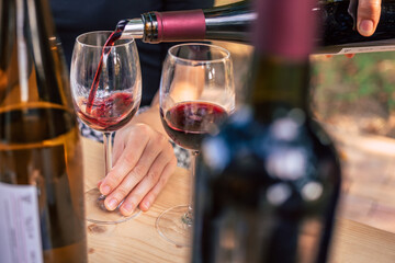 A person pouring wine to a glass