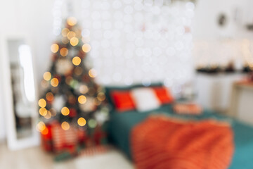Cozy blur bokeh flat apartment room green Christmas Tree gifts presents garlands, candles decorated...