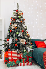 Vertical photo cozy flat apartment photo studio room green Christmas Tree gifts presents garlands, candles decorated toys balls interior New Year lights glowing bokeh