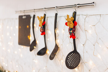 Cozy flat apartment photo studio room kitchen utensils gifts presents garlands, candles decorated toys balls interior New Year lights glowing bokeh
