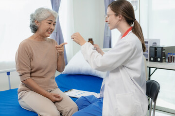 Female doctor with clipboard talking with elderly female patient at hospital Senior woman or doctor with digital tablet Consult or plan treatment to treat medical professionals with female patients.