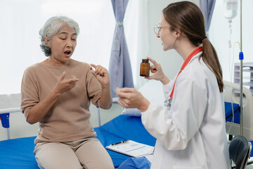 Female doctor with clipboard talking with elderly female patient at hospital Senior woman or doctor with digital tablet Consult or plan treatment to treat medical professionals with female patients.