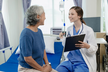 Female doctor with clipboard talking with elderly female patient at hospital Senior woman or doctor with digital tablet Consult or plan treatment to treat medical professionals with female patients.