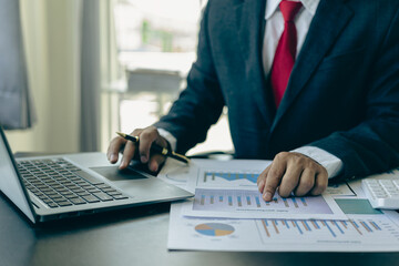 Law and Justice Lawyer working with documents and laptop, hammer, scale at wooden table in office Close-up of judge in suit or lawyer Legal advice and services