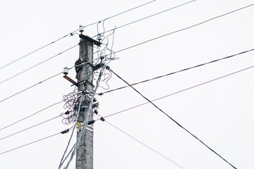 High voltage construction power lines electricity pylon in the village or city
