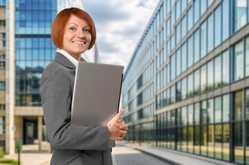 Fototapeta premium Happy young business woman in city street, AI generated image