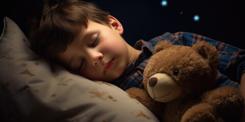 Young toddler asleep with his teddy bear at night 