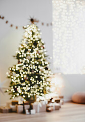Defocused magic christmas interior with christmas tree, stars, gifts and decoration, Winter holiday...
