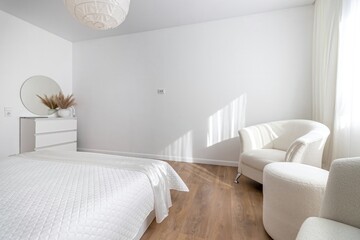 Modern bedroom in white tones with white furniture