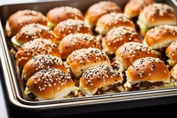 a tray of mixed bbq sliders with sesame seeds topping
