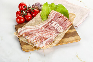 Sliced pork bacon oved board