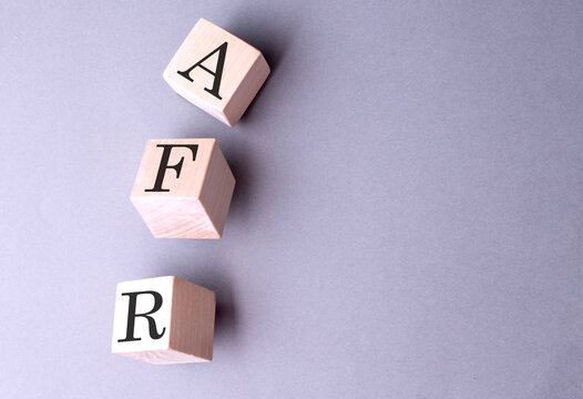 Word AFR on wooden block on the grey background