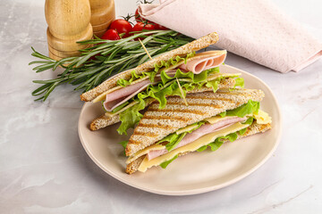 Homemade club sandwich with ham and cheese