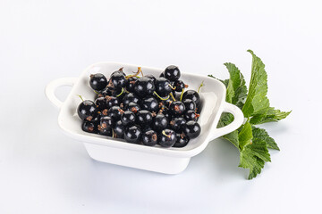 Juicy black currant berries in the bowl