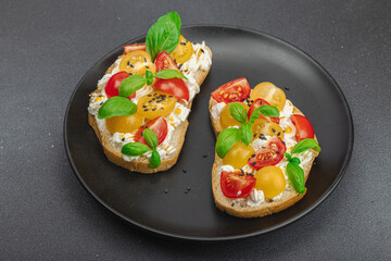 Fresh bread sandwiches with tomato cherry, cream cheese and basil leaves. Morning breakfast concept