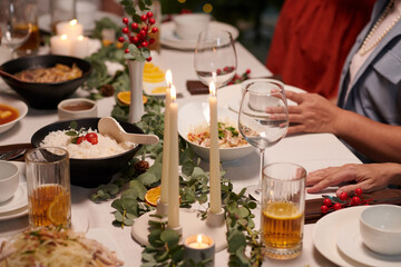 Delicious food, candles and wine glasses on Christmas dinner table
