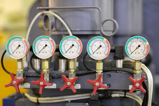 closeup of industrial machine with pressure gauges
