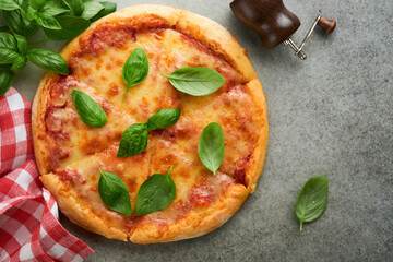 Margarita pizza. Traditional neapolitan margarita pizza and cooking ingredients tomatoes basil on wooden table backgrounds. Italian Traditional food. Top view. Mock up.