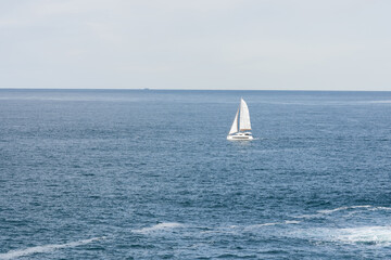 Sailboat on opened sea. Sailing at windy day.