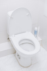 White toilet with open lid. Toilet morning procedures.