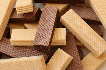 Stacked delicious chocolate wafers in large amount. Two different flavours of classic small waffles