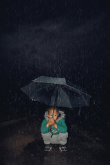 boy with umbrella in rain