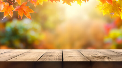Naklejka na ściany i meble Blurred nature background with colorful autumn leaves on sunny day with empty plank wood table in the forefront for product placement presentation