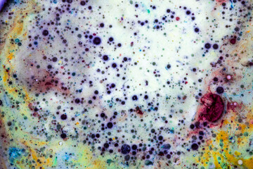 Colorful liquid paint forming a colorful abstract work of art without defined shapes. Abstract art