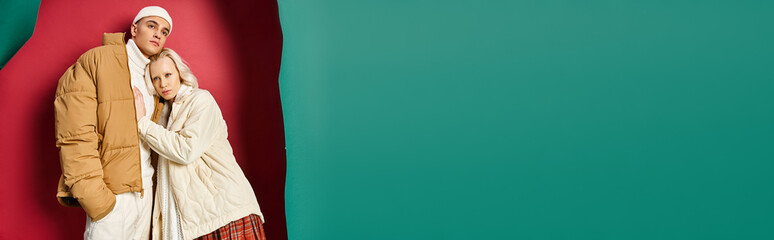 banner of romantic couple in winter jackets standing together near torn turquoise and red background