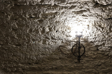 Lighted medieval castle torch hanging on a stone wall, vintage objects and background