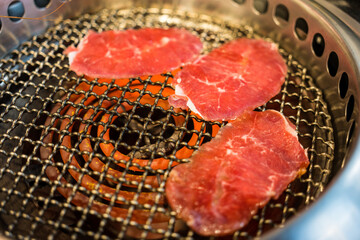 Soft tender beef or pork eating at a Japanese yakiniku restaurant. Family dinner