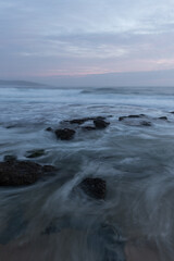 Cloudy view from rocky beach coastline.