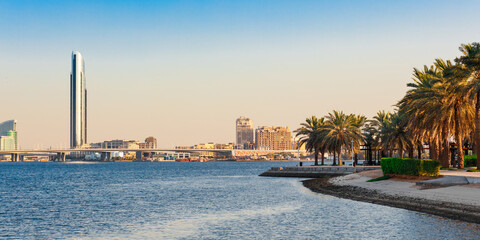 Obraz premium Dubai Creek bay with skyscrapers and palm trees in UAE