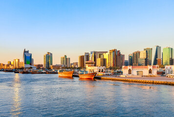 Fototapeta premium Dubai Creek bay with skyscrapers, traditional boats and piers in UAE
