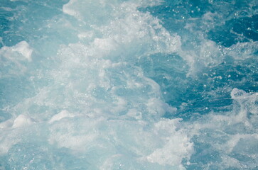 Stormy sea, strong waves. A trace on the sea from a boat or yacht. Ocean close-up, beautiful water color
