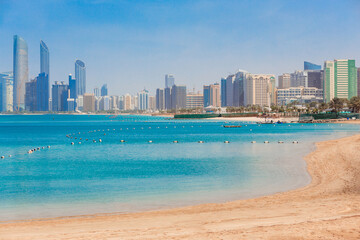 Obraz premium Cityscape Abu Dhabi with sea, beach and skyscrapers. Travel in UAE