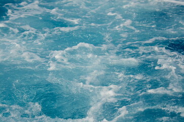 Stormy sea, strong waves. A trace on the sea from a boat or yacht. Ocean close-up, beautiful water color