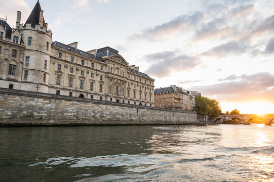 Sunset at Pont Neuf, the oldest standing bridge across river Seine in Paris, France with grotesk heads representing forest and field divinities from ancient mythology.