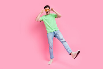 Full body view photo of attractive funky guy dancing have fun touch specs sunglasses discotheque party isolated on pink color background