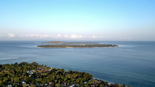 Aerial drone footage of Gili Travangan Island in the ocean, Tropical Island Indonesia