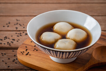 Fototapeta na wymiar Glutinous rice balls filled with black sesame in sweet ginger soup