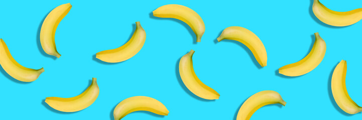 Banana isolated on blue background. panorama, banner. Bananas texture design for textiles,...
