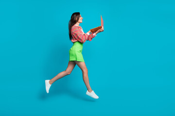 Fototapeta na wymiar Full length profile side photo of charming cheerful girl browsing sms message running empty space isolated on cyan color background