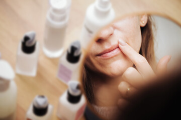 Woman using petrolatum on her mouth. Closeup lips background. Applying lip salve on lips with...