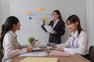 Business People Meeting using laptop computer,calculator,notebook,stock market chart paper for analysis Plans to improve quality next month. Conference Discussion Corporate Concept.