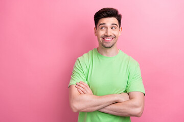 Portrait of good mood model guy folded arms looks empty space confident deciding new business plans isolated on pink color background