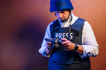 Reporter in bulletproof vest with a camera.