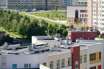 Top view of the flat roof of a modern air-conditioned building. The roof is covered with waterproofing membranes.