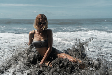 Sexy athletic girl posing against the background of the ocean